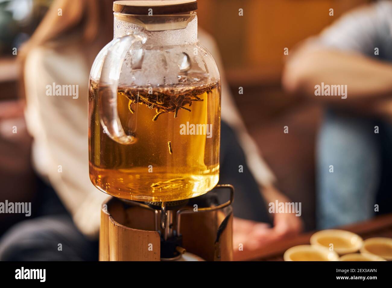Glass teapot with tea on portable gas burner Stock Photo - Alamy
