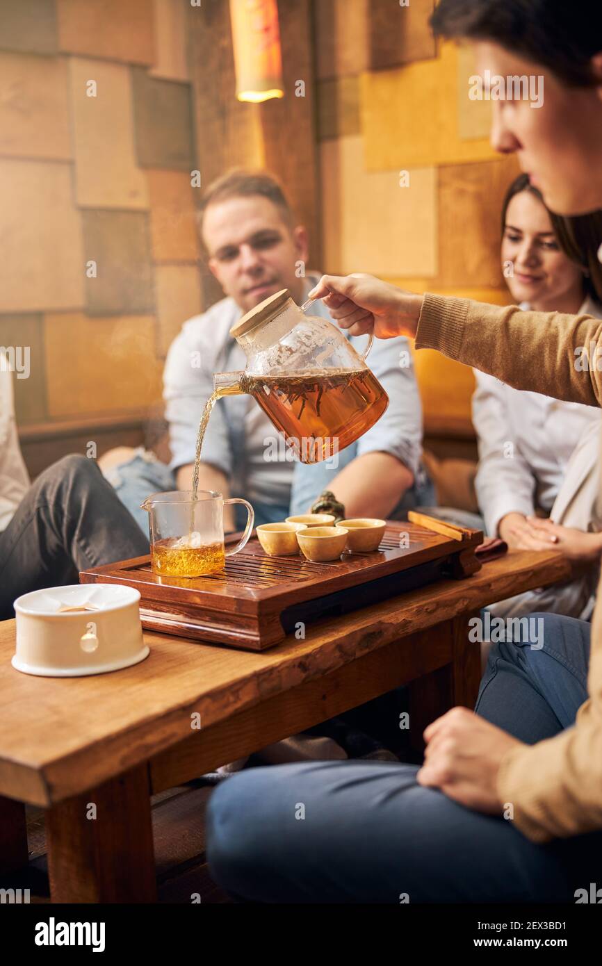 Handsome man performing traditional tea ceremony in cafe Stock Photo