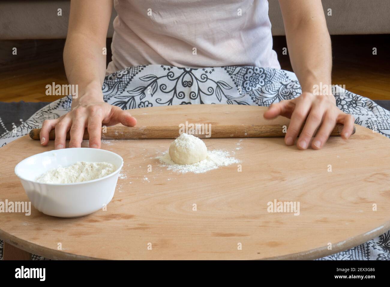Homemade lahmacun preparation from start to finish. Dough rolls on the floor table Stock Photo