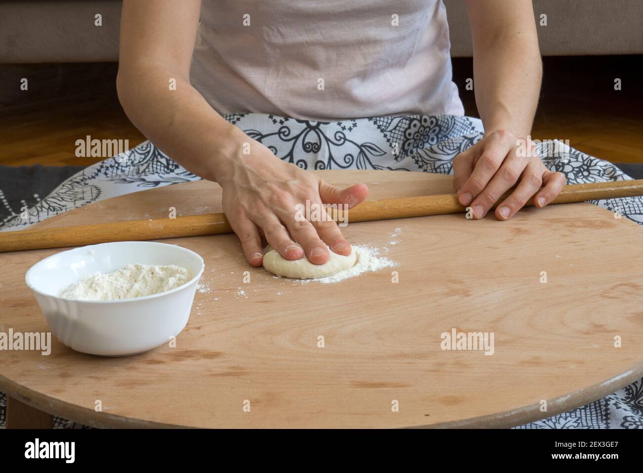 Homemade lahmacun preparation from start to finish. Dough rolls on the floor table Stock Photo