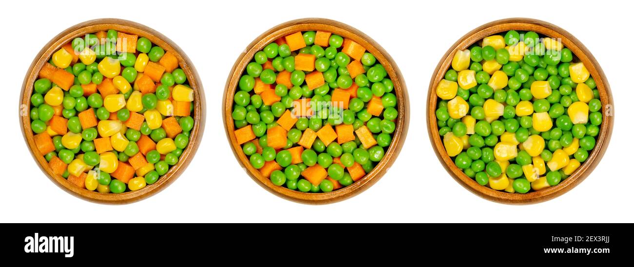 Mixed vegetables in wooden bowls. Three mixes of green peas, corn and carrot cubes. Mix of peas, carrots cut in cubes and vegetable maize. Stock Photo