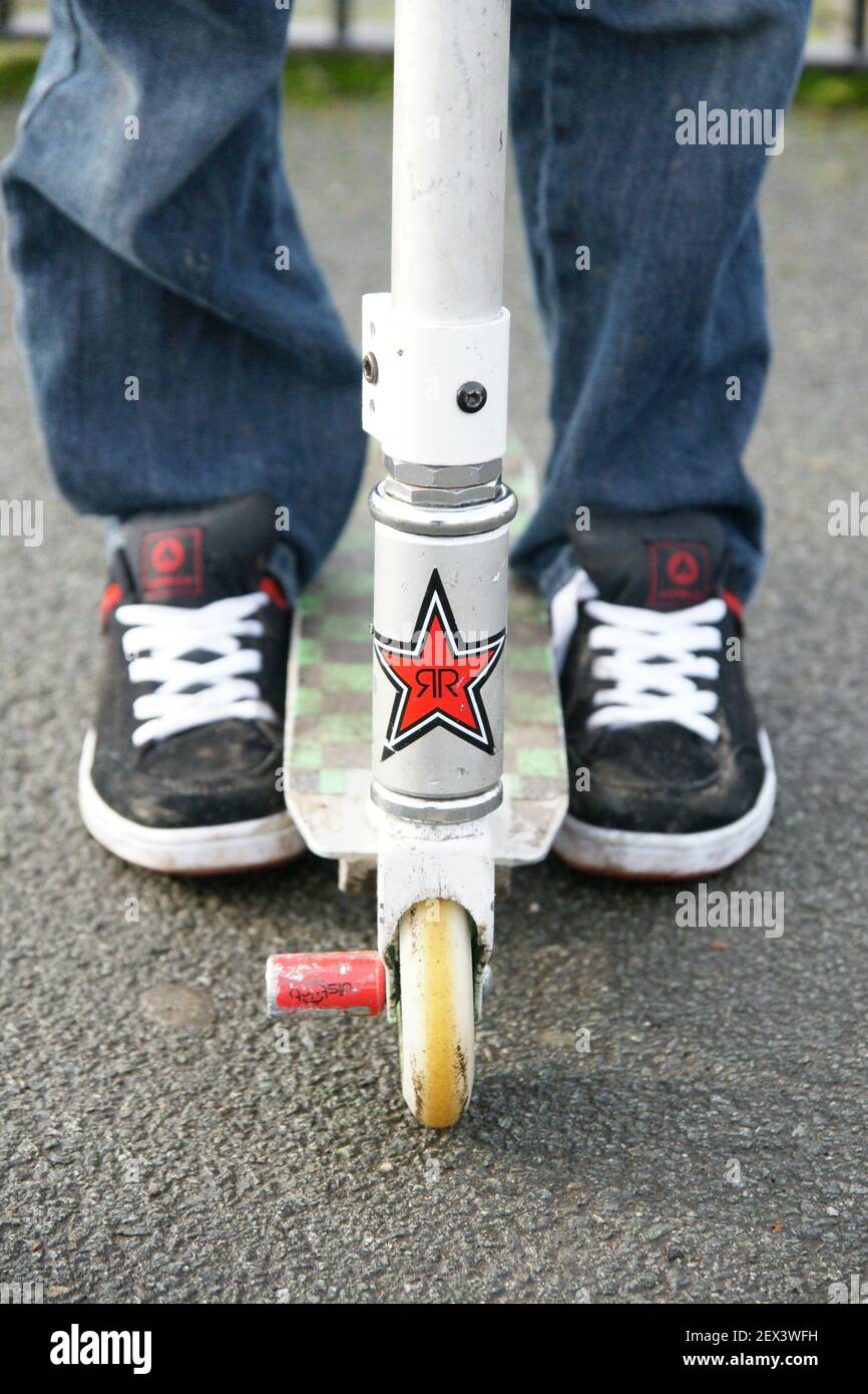 A view of well worn scooter used for stunt riding at a skate park Stock Photo