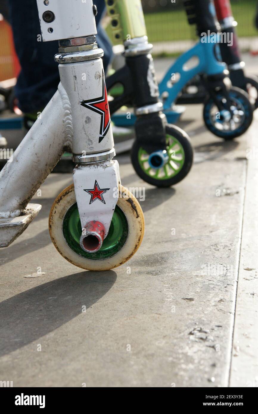 A view of well worn scooters used for stunt riding at a skate park Stock Photo
