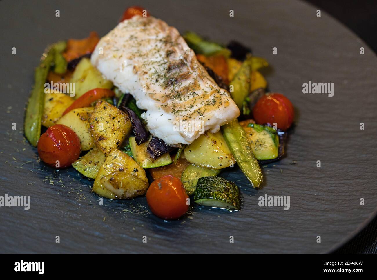 roasted cod fillet on mediterranean vegetables Stock Photo