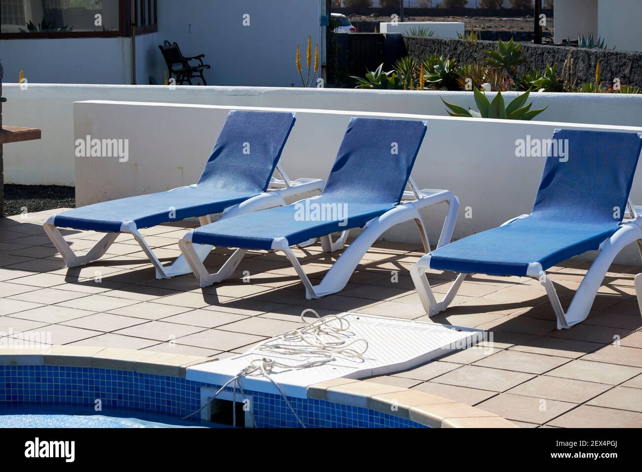 empty sun lounger chairs in empty villa in Lanzarote Canary Islands Spain Stock Photo