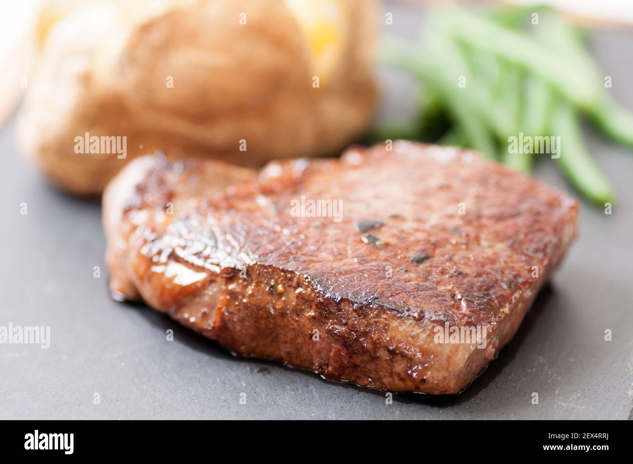 tenderloin steak with baked potato and green beans Stock Photo - Alamy
