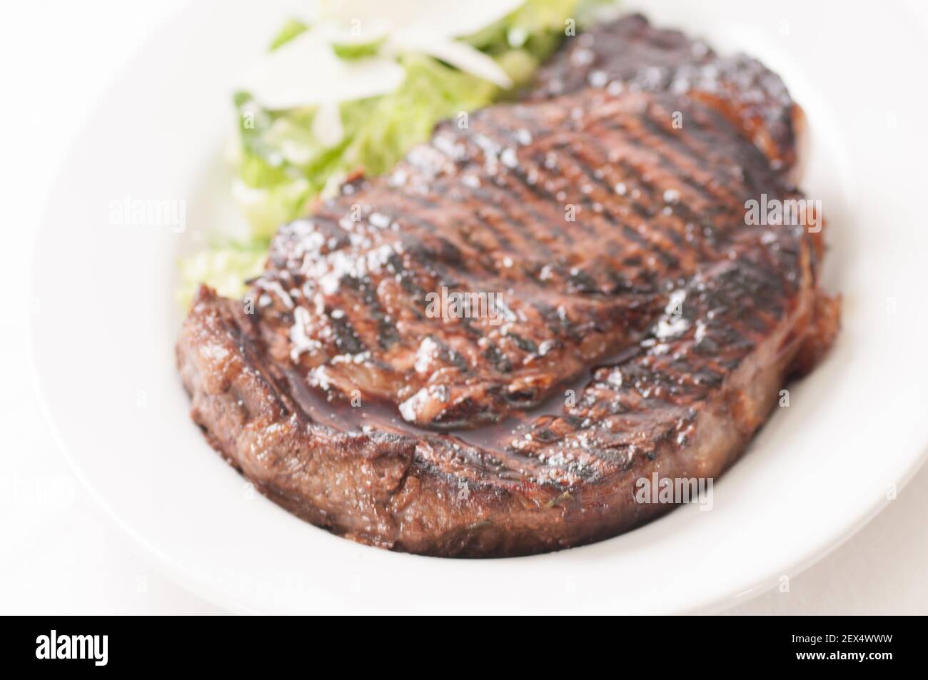 thick ribeye steak seared rare on a cast iron grill Stock Photo Alamy