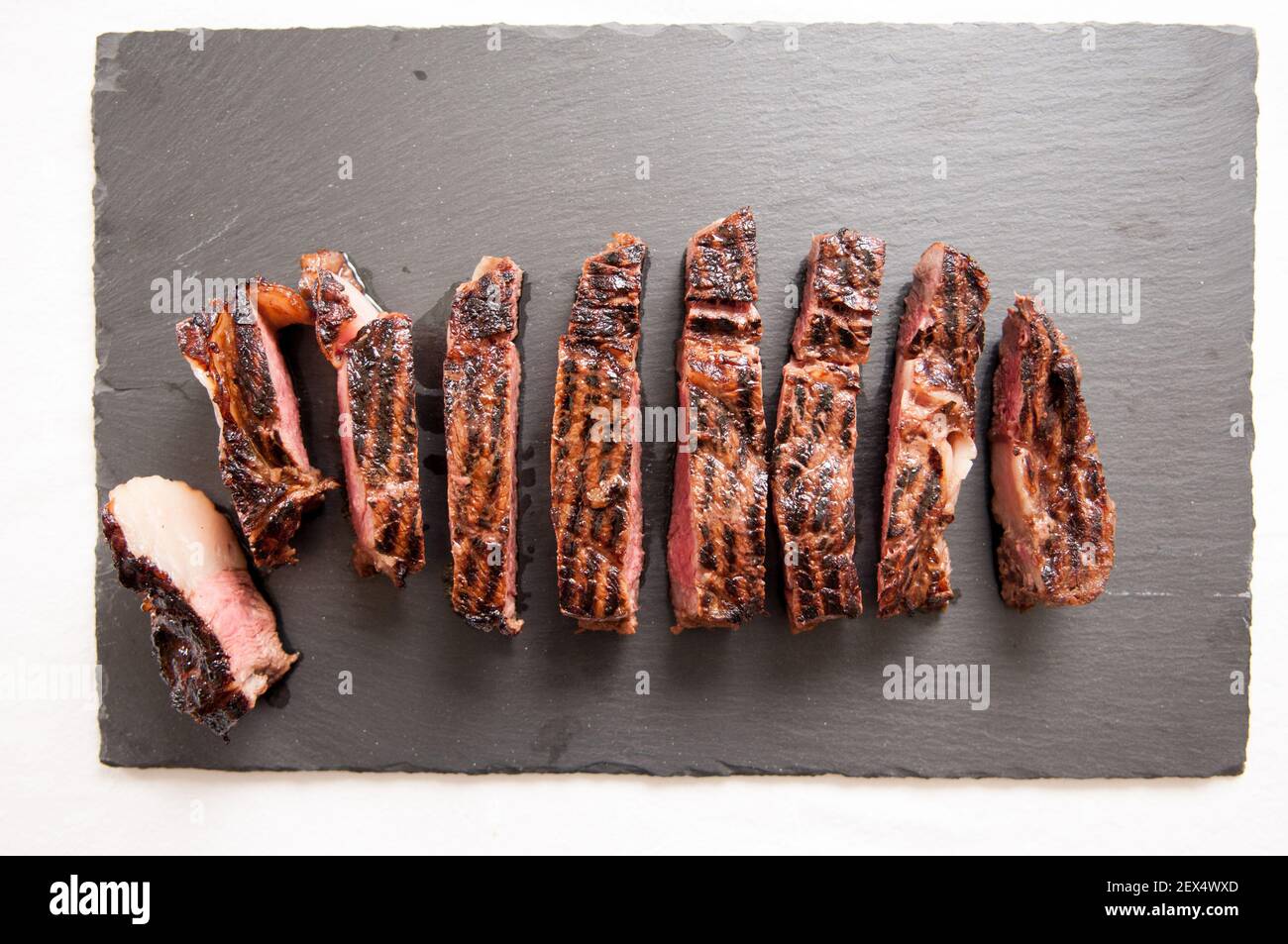 thick ribeye steak seared rare on a cast iron grill Stock Photo Alamy