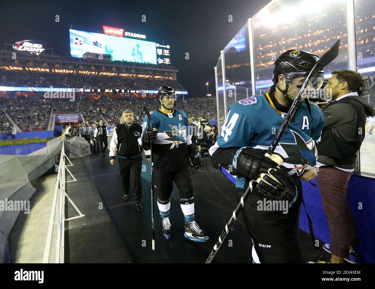 From left, San Jose Sharks head coach Todd McLellan, forward Patrick  Marleau (12), and defenseman San Jose Sharks' Marc-Edouard Vlasic (44)  return to the bench against the Los Angeles Kings to start