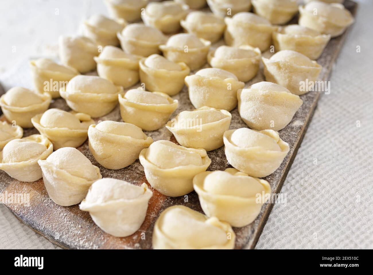 homemade dumplings in the kitchen without decorations. making dumplings with minced pork, beef and chicken Stock Photo