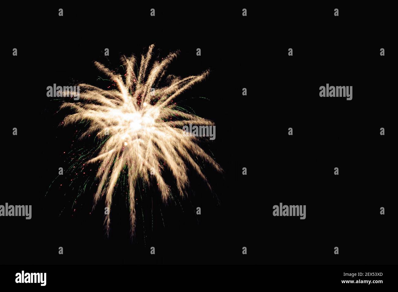 Image with a black background prepared to edit text of a firework, formed by a star with several branches of raw white color accompanied by traces and Stock Photo