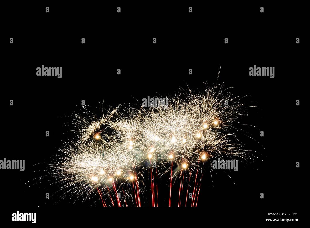 Image with a black background prepared to edit text of a firework, formed by a star of several branches of raw white color accompanied by red traces a Stock Photo