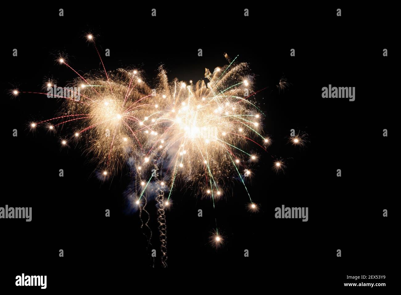 Image with a black background prepared to edit text of a firework, formed by a star with several branches of raw white color accompanied by red and gr Stock Photo