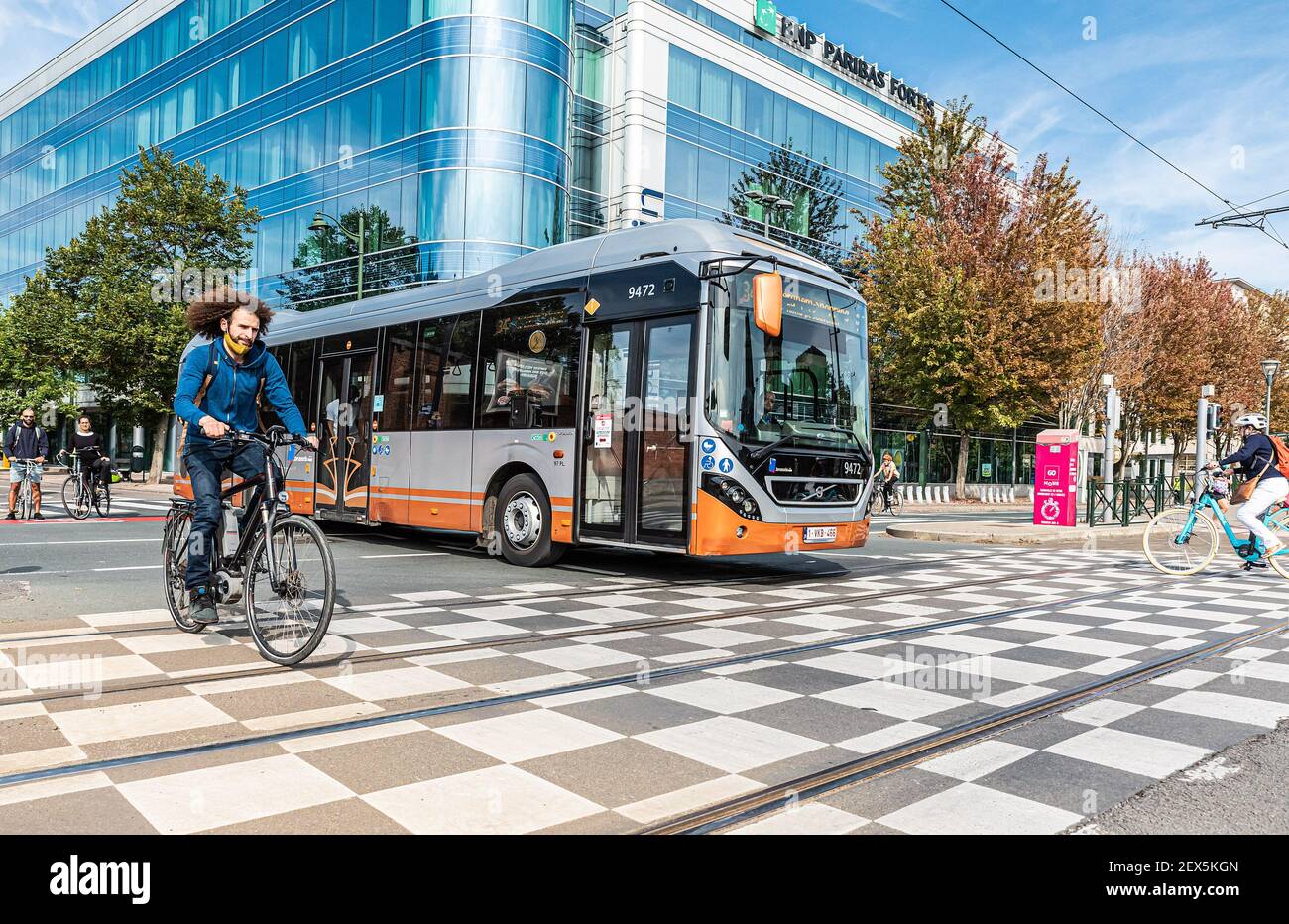 Maghreb man with curling hair and an Urban bus at the car free sunday Stock Photo