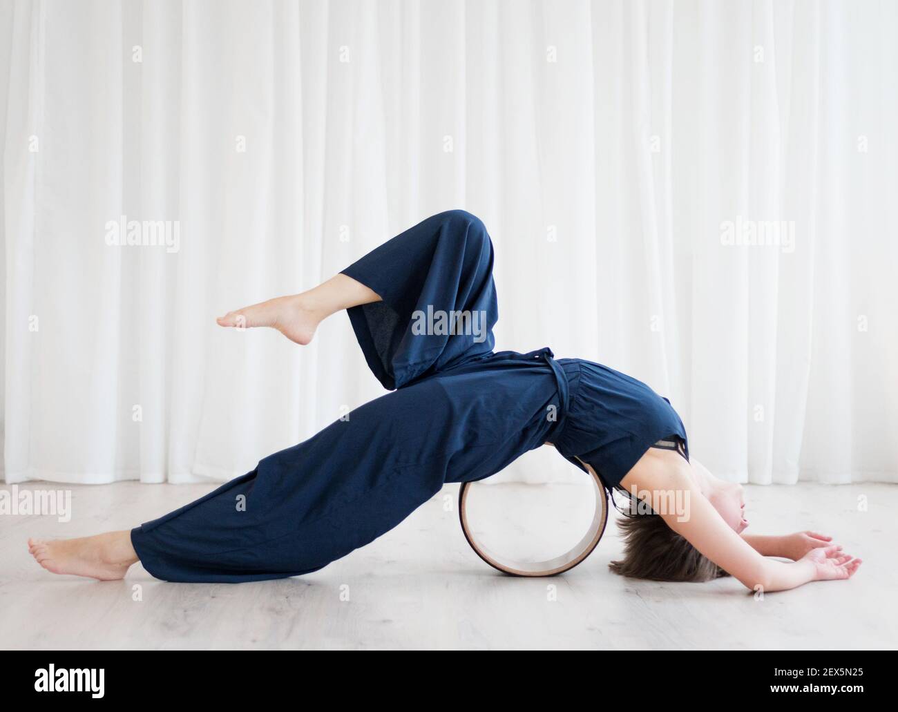 Woman doing stretching on a yogo ring Stock Photo