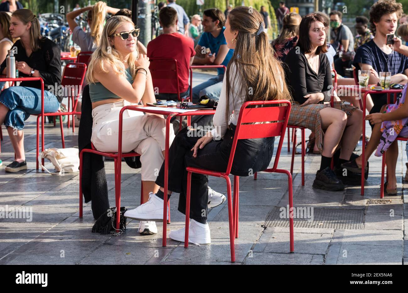 Ixelles, Brussels Capital Region / Belgium - 07 15 2020: Young people enjoying a sunny terrace at the Flagey square with friends Stock Photo