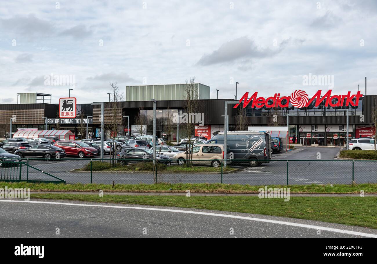 Ghent, Flanders, Belgium - 02 20 2021: The Mediamarkt and Delhaize retail shops and parking Stock Photo