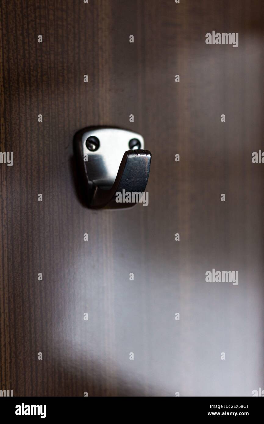 Steel hook on a wooden wall in a train car Stock Photo