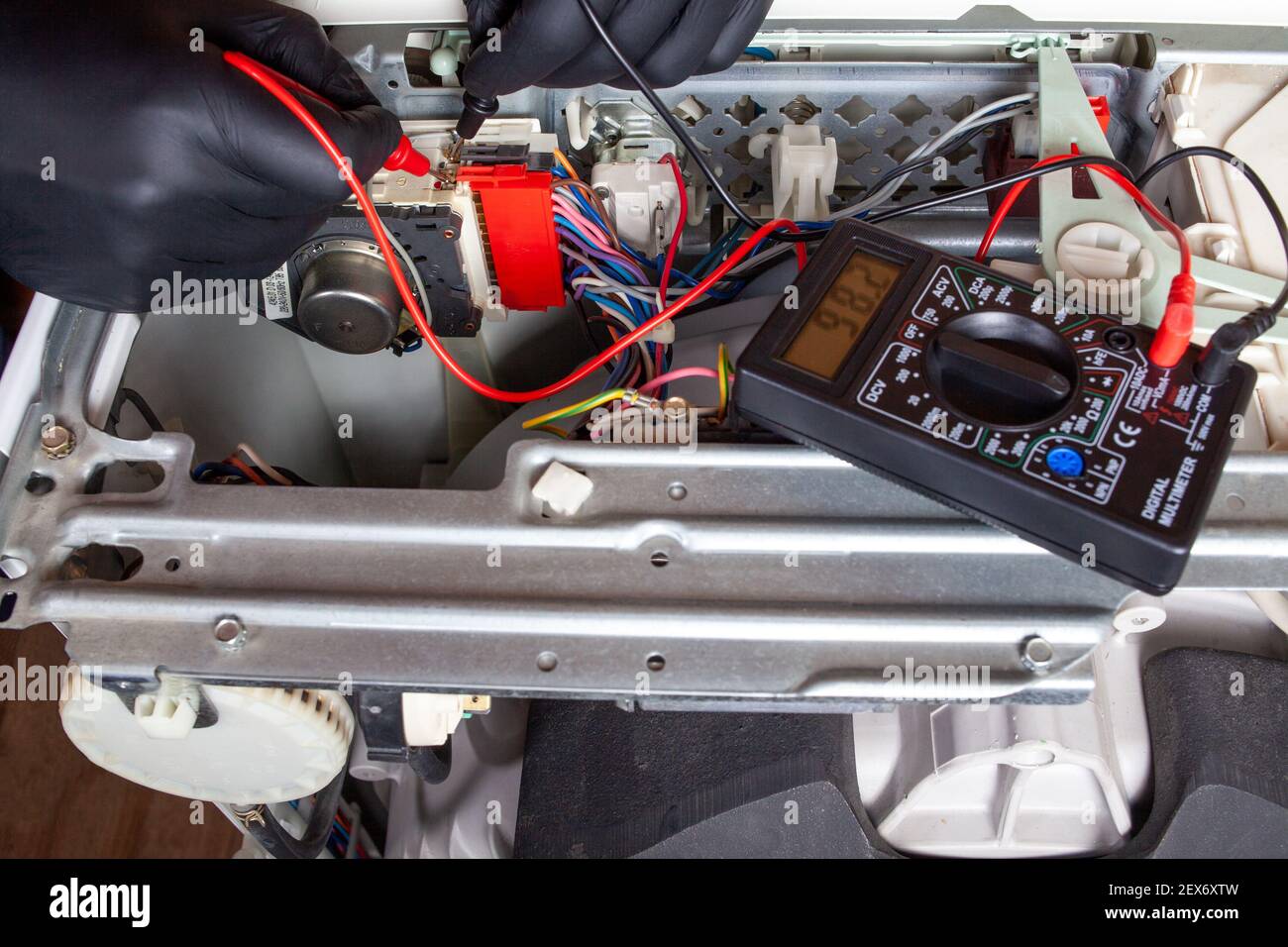 Electronics repair service master using multimeter tester to