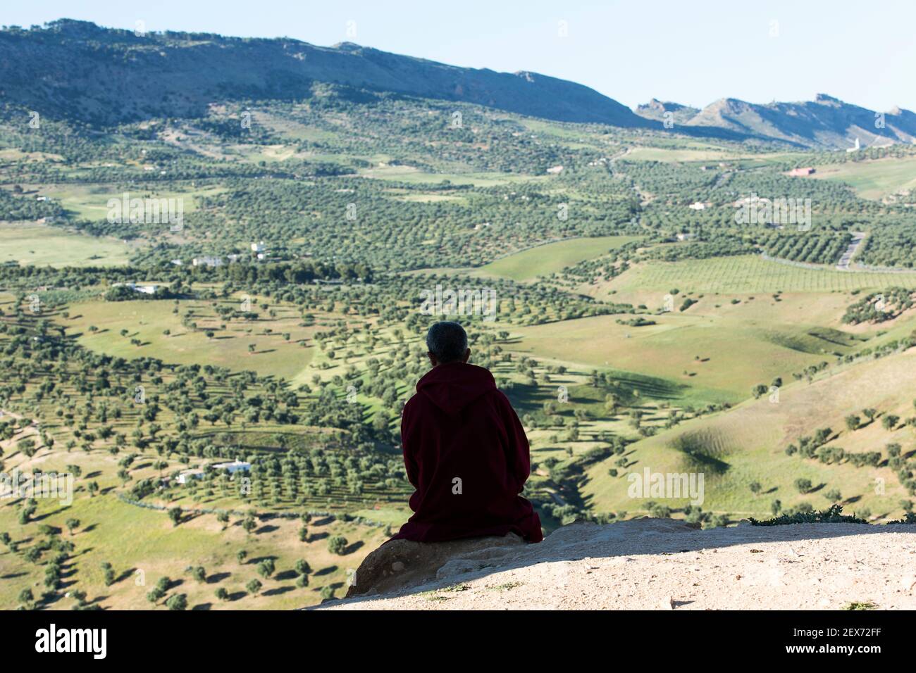 Morocco, Fez, silhouette of a person looking out at landscape view of green hills surrounding the city Stock Photo