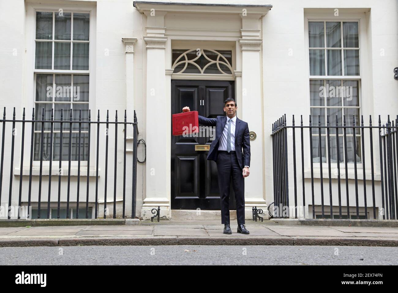London, UK. 03rd Mar, 2021. Rishi Sunak the Chancellor of the Exchequer with the red Budget Box outside Number 11 Downing Street before he delivers his Budget speech in The House of Commons at lunchtime. Budget Day, Downing Street, Westminster, London, March 3, 2021. Credit: Paul Marriott/Alamy Live News Stock Photo