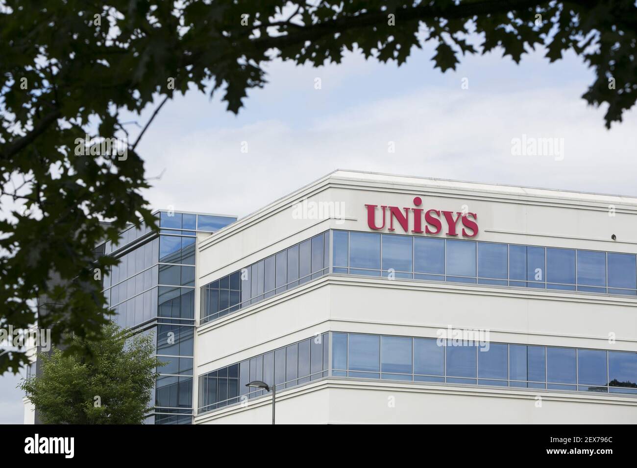 A logo sign outside of the headquarters of Unisys Corporation in Blue