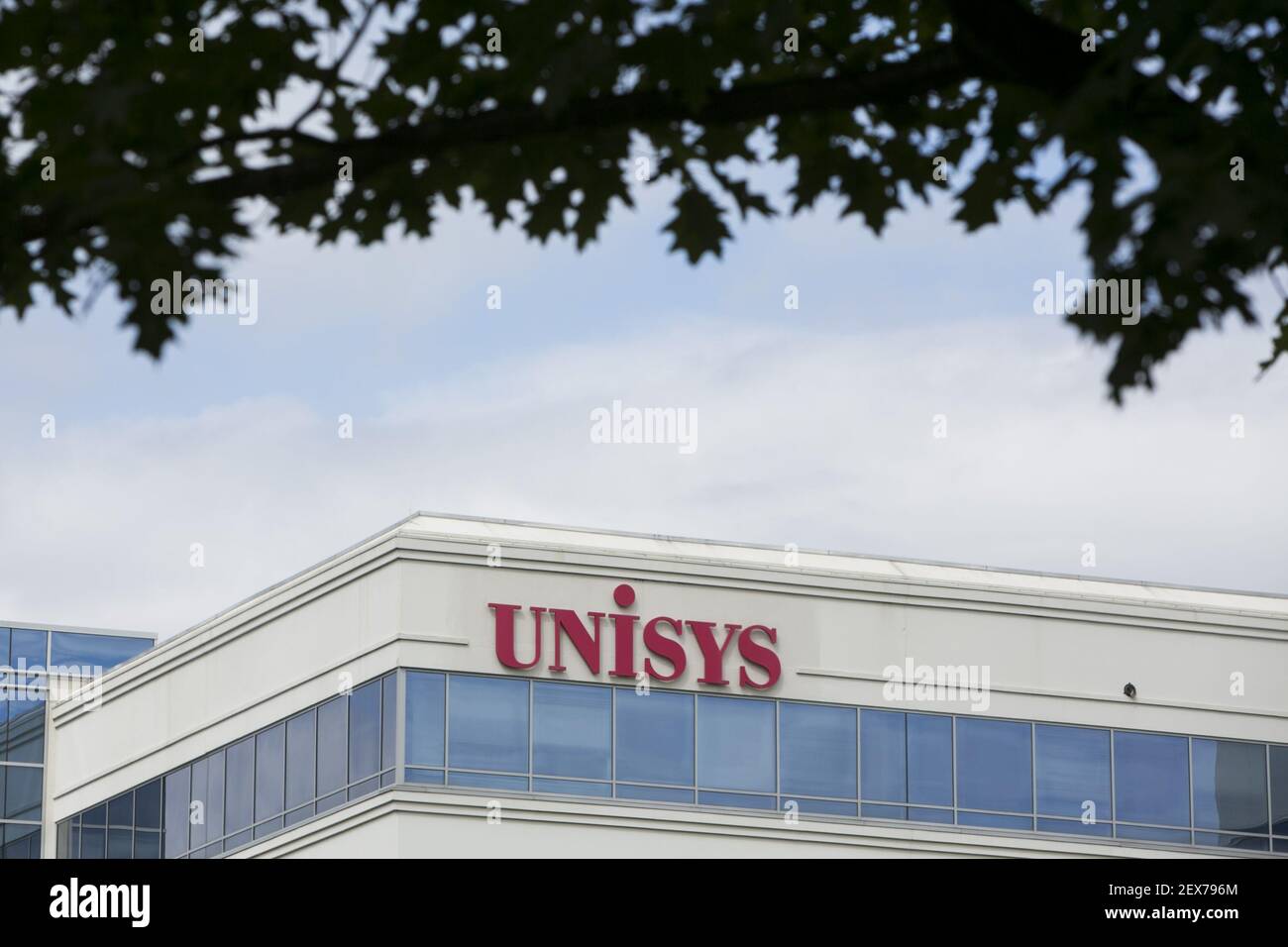 A logo sign outside of the headquarters of Unisys Corporation in Blue