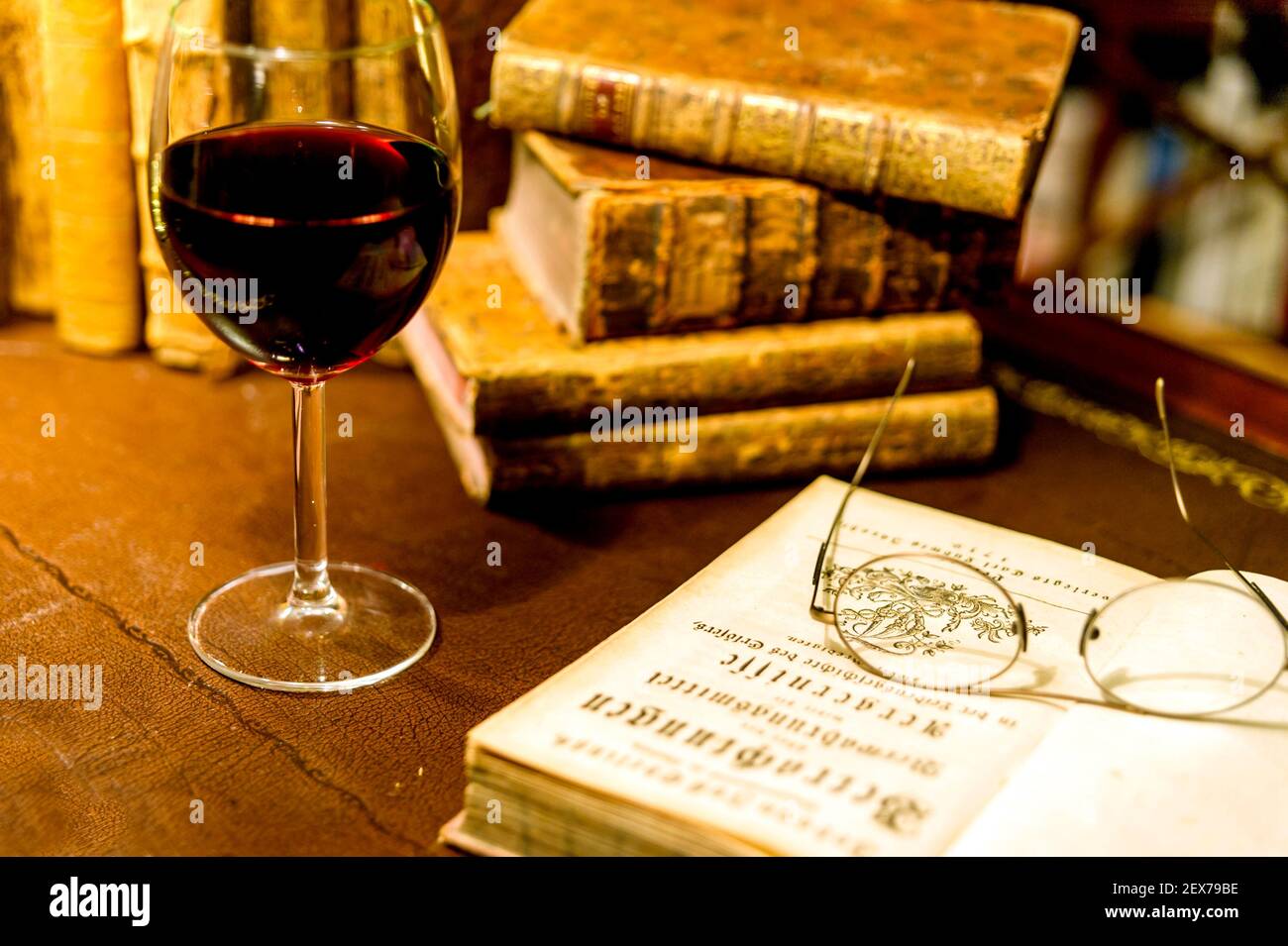 Old books and a glass of wine Stock Photo