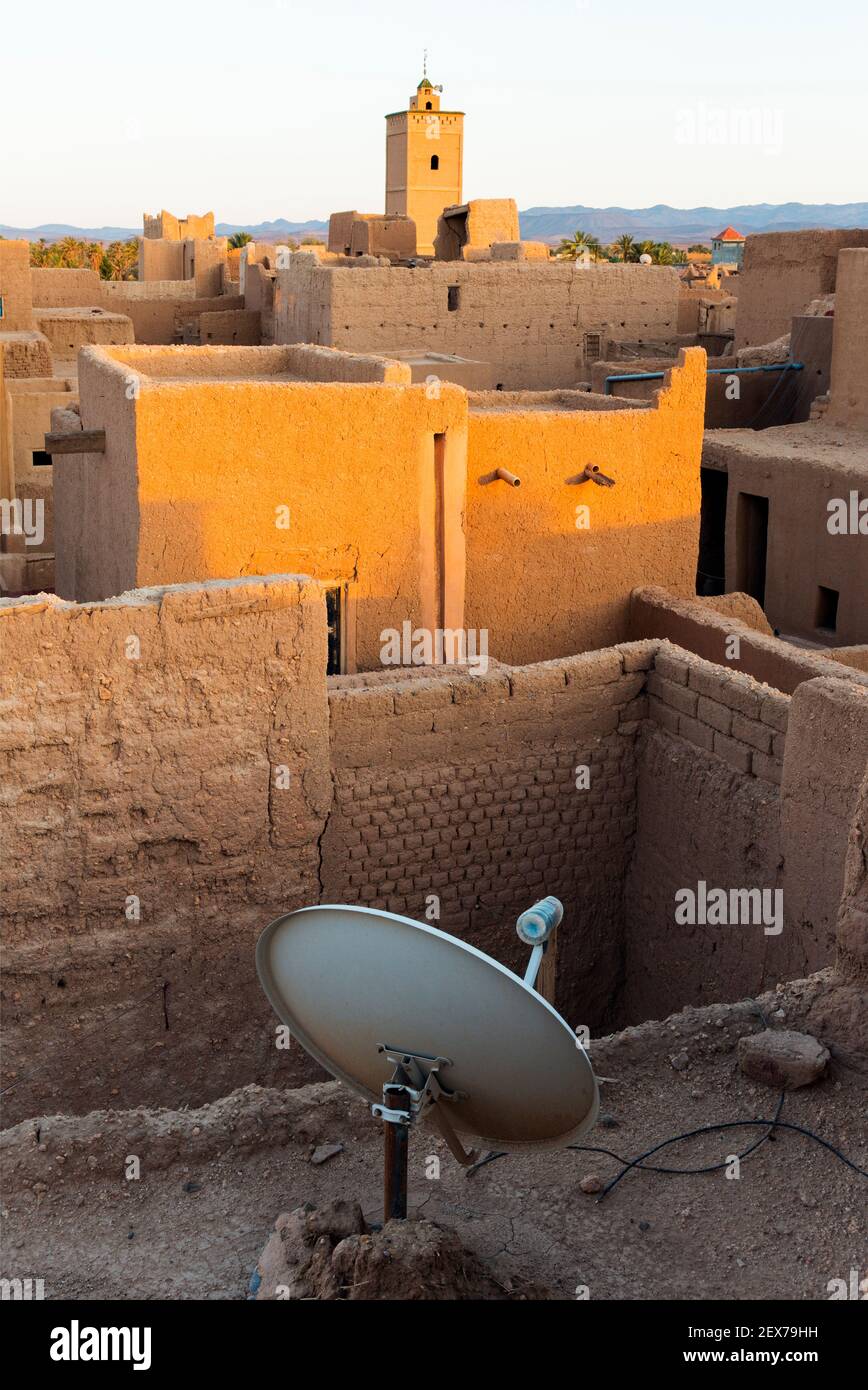 Morocco, Tinejdad, Todra Valley, Ksar El Khorbat, is a village of  fortified walls made of soil, with satellite dish Stock Photo