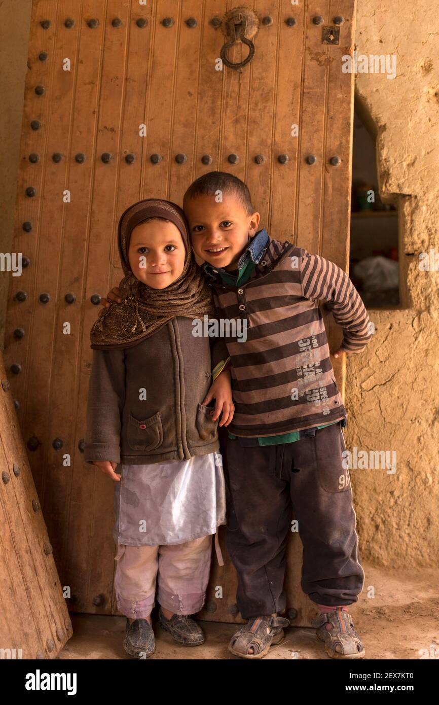 portrait of young  Moroccan brother and sister against a wooden door Stock Photo