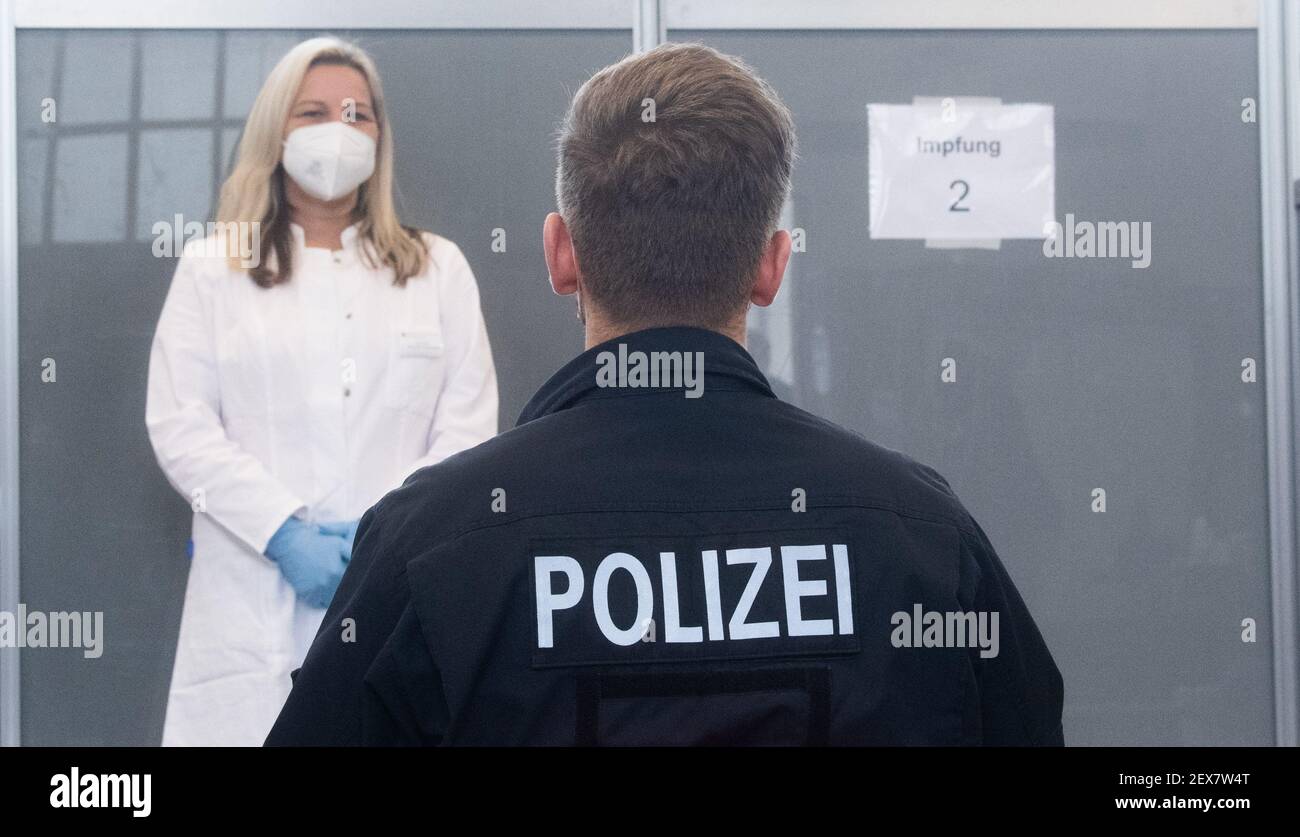 04 March 2021, Lower Saxony, Hanover: A police officer waits to be vaccinated against the Corona virus at the Lower Saxony Central Police Directorate. Prioritized vaccination of police officers has begun in Lower Saxony. Photo: Julian Stratenschulte/dpa Stock Photo