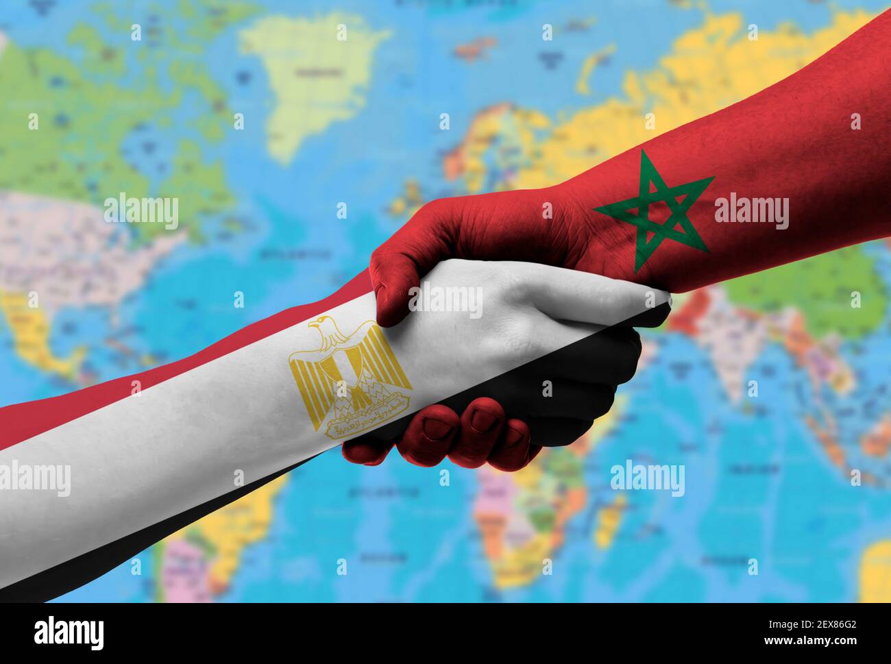 Handshake between egypt  and morocco flags painted on hands, illustration with clipping path. Stock Photo