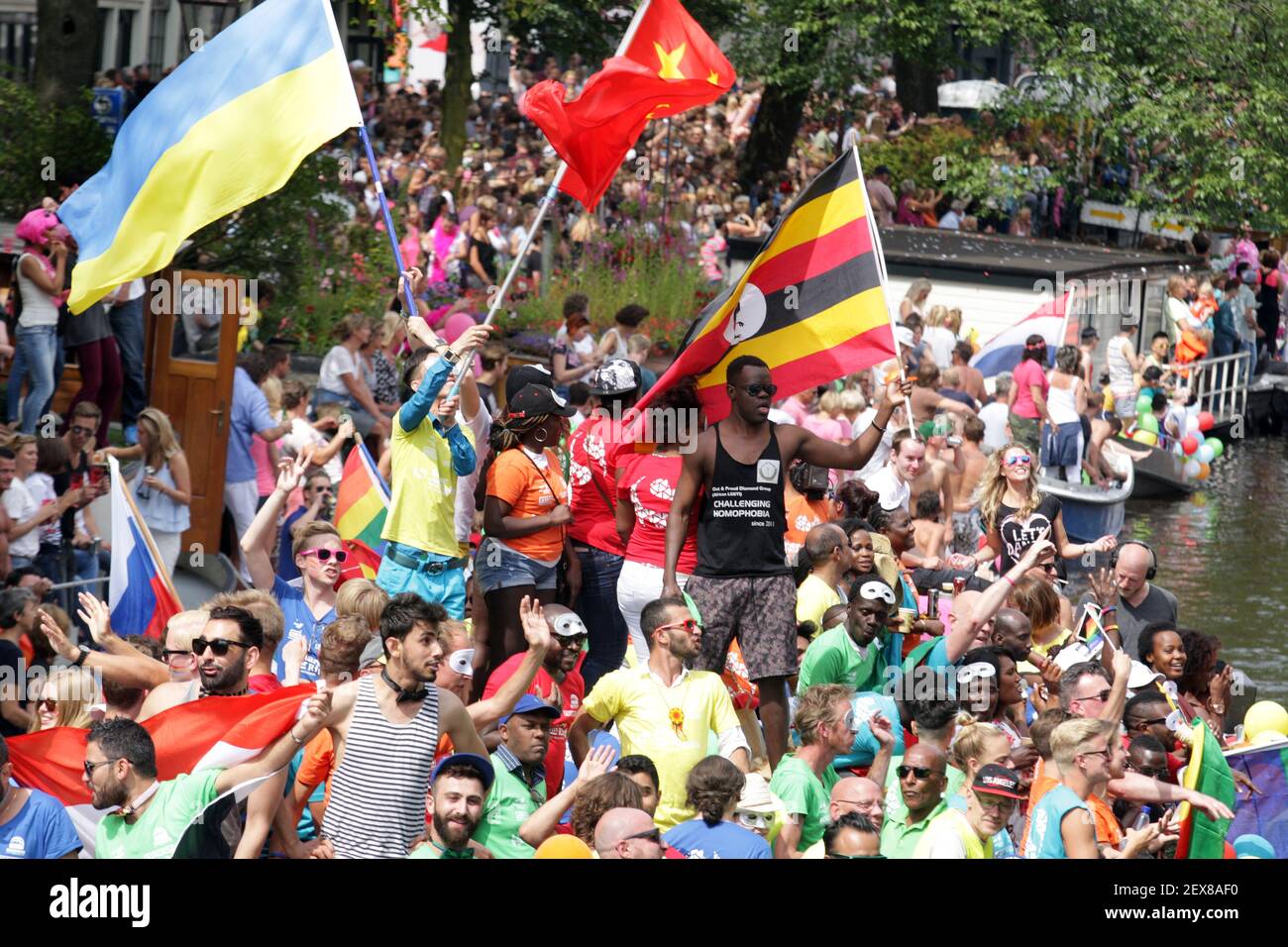 Revelers on a boat parade the Prinsengracht canal participating in the