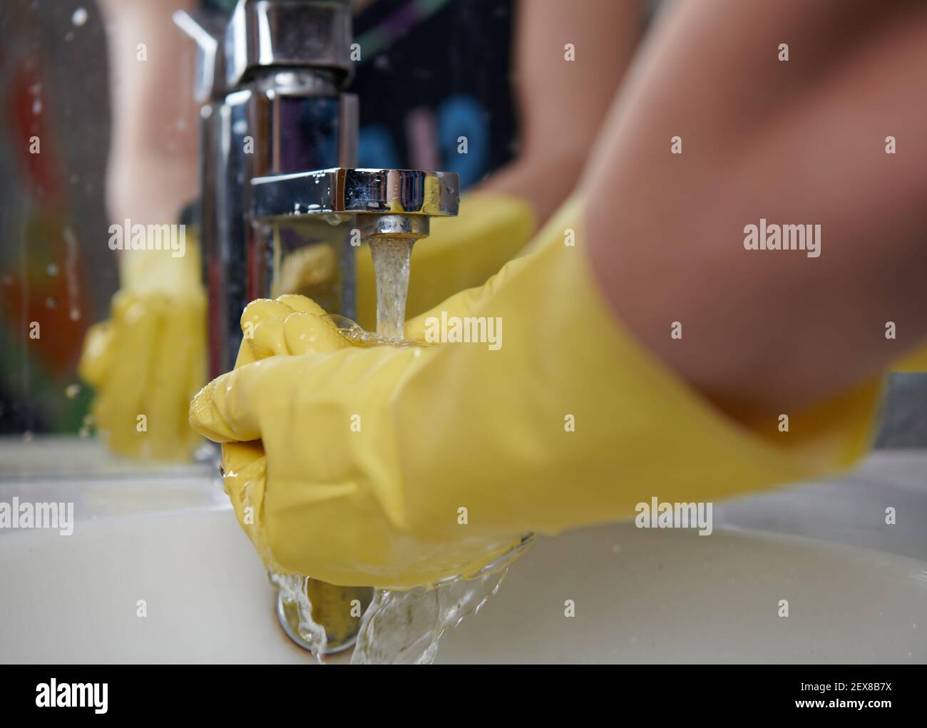 washing hands in yellow rubber gloves with water Stock Photo - Alamy