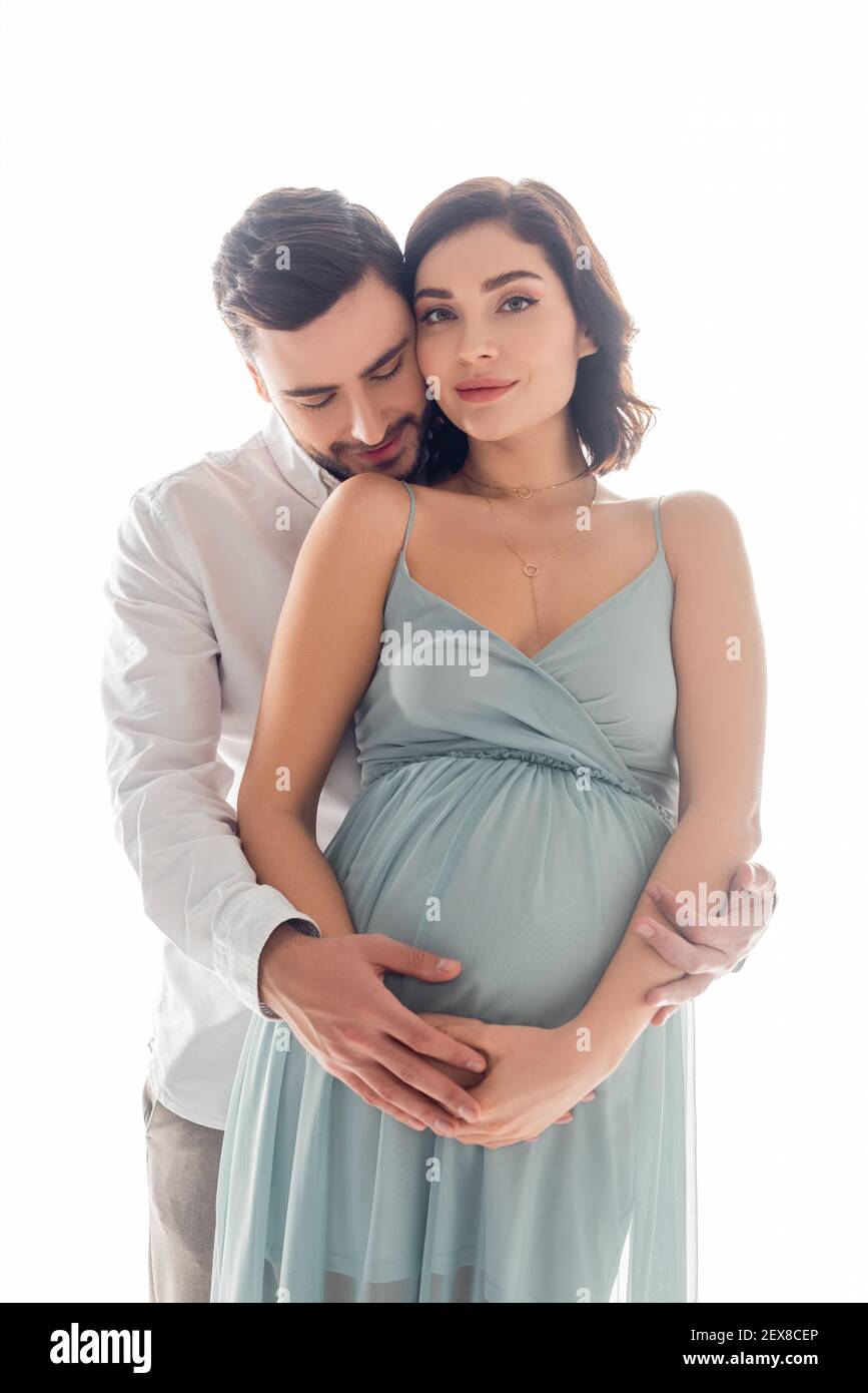 Bearded man hugging pretty pregnant wife isolated on white Stock Photo ...