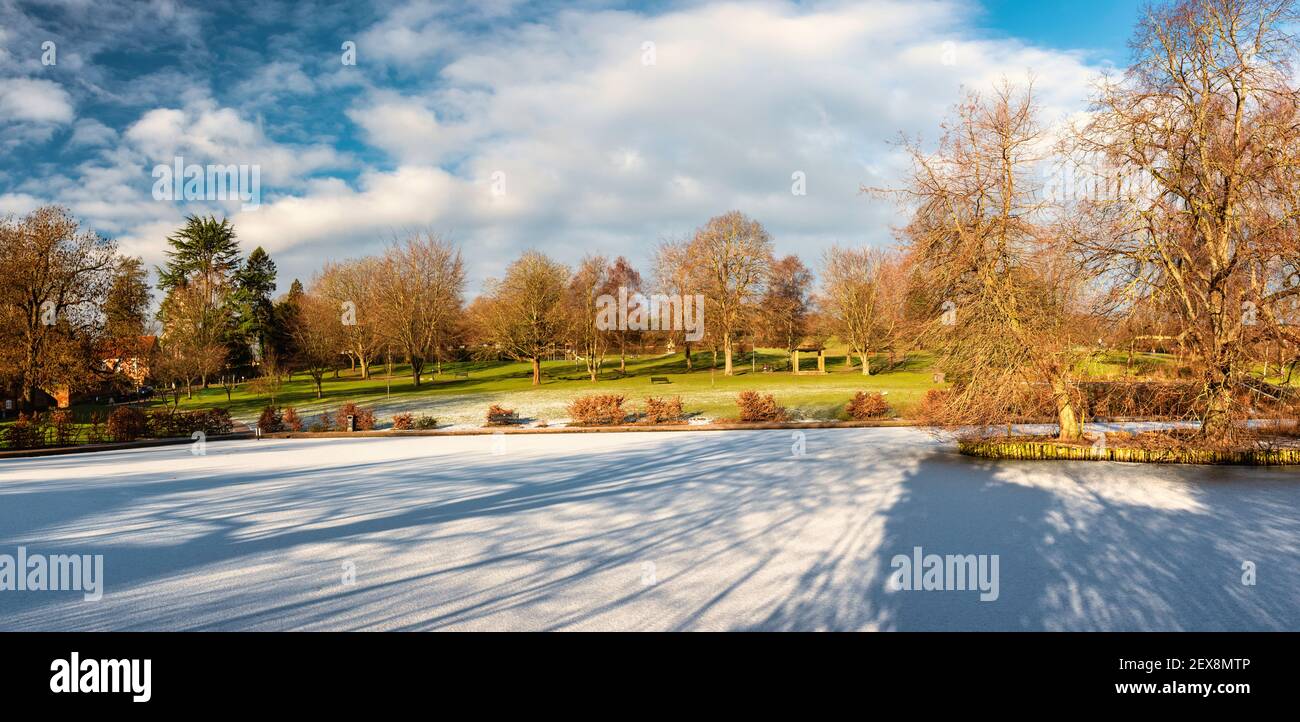 Lowndes Park in Chesham, England with completely frozen Skottowe's Pond in winter Stock Photo