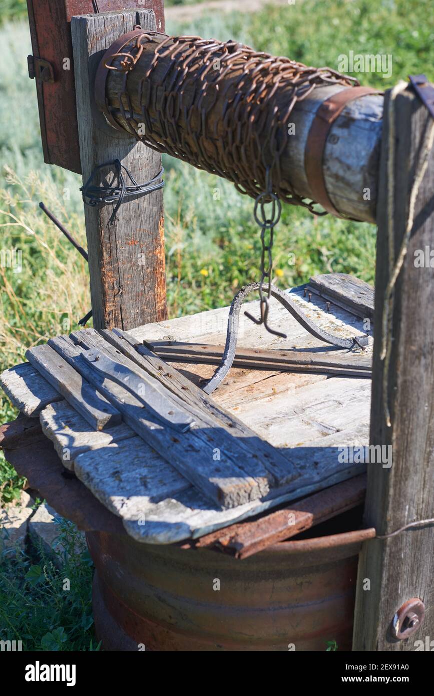 Modern Rustic Wooden Water Extraction Well Rusty Chain Stock Photo