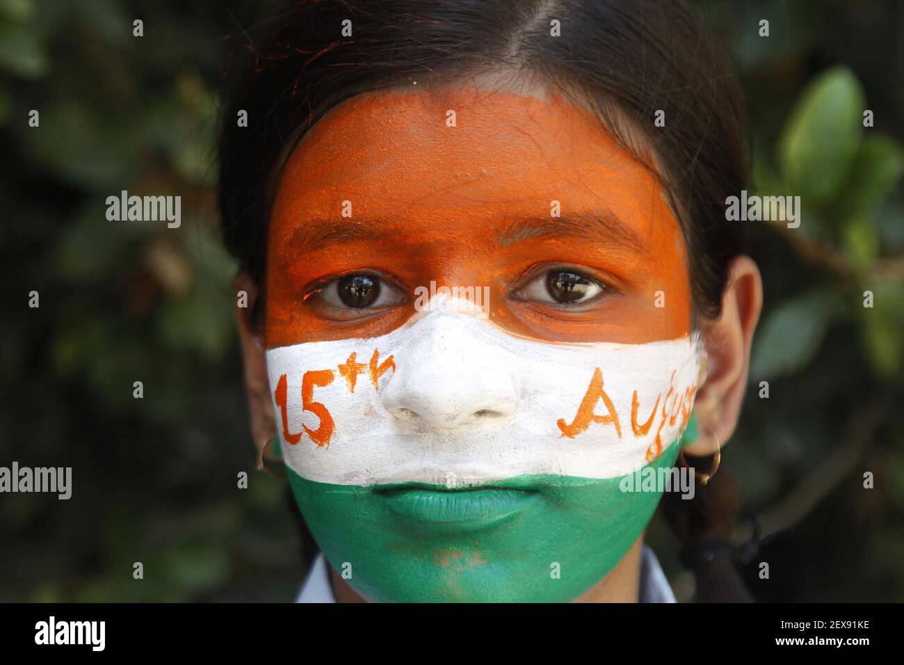 School children paint their faces with the Indian flag painted to ...