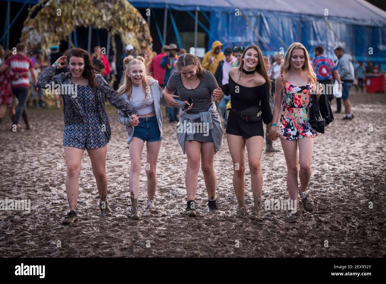Festival goers walking through mud on day 3 of Bestival 2016, Robin Hill Country Park on the Isle of Wight.Picture Date: Saturday 10th September 2016.  Photo credit should read:  David Jensen Stock Photo