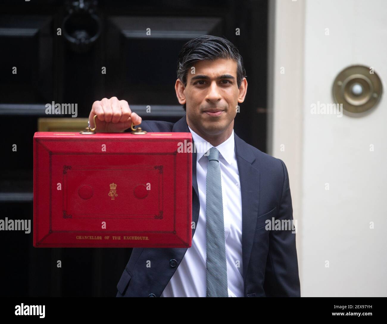 Chancellor of the Exchequer, Rishi Sunak, holds up the famous red briefcase,  Gladstone's Red box, before heading to Parliament to deliver his budget  Stock Photo - Alamy