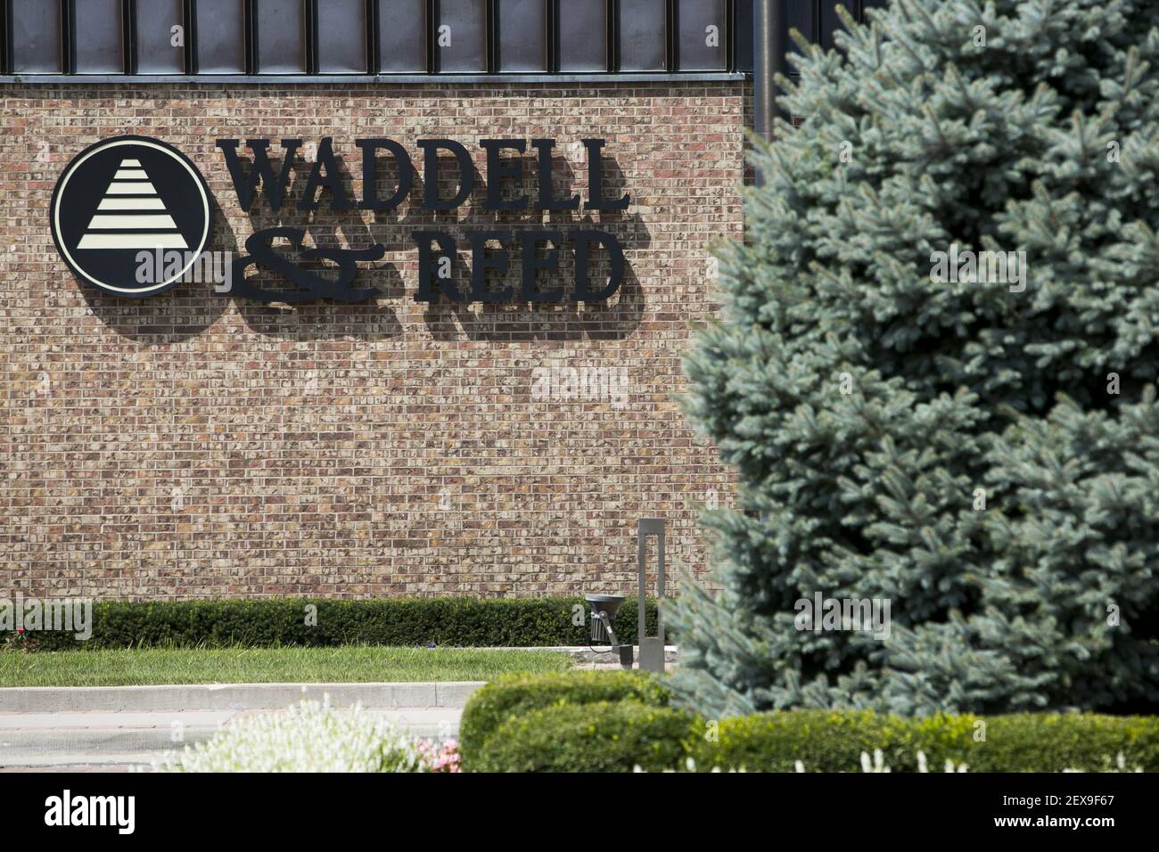 A logo sign outside of the headquarters of Waddell & Reed Financial, Inc., in Overland Park