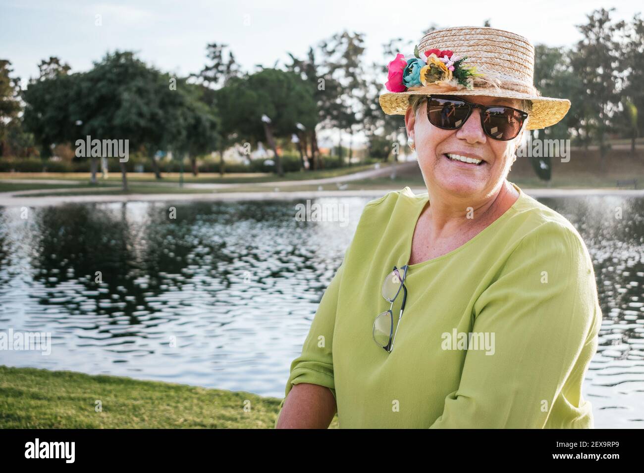 portrait of smiling retired woman wearing a hat Stock Photo