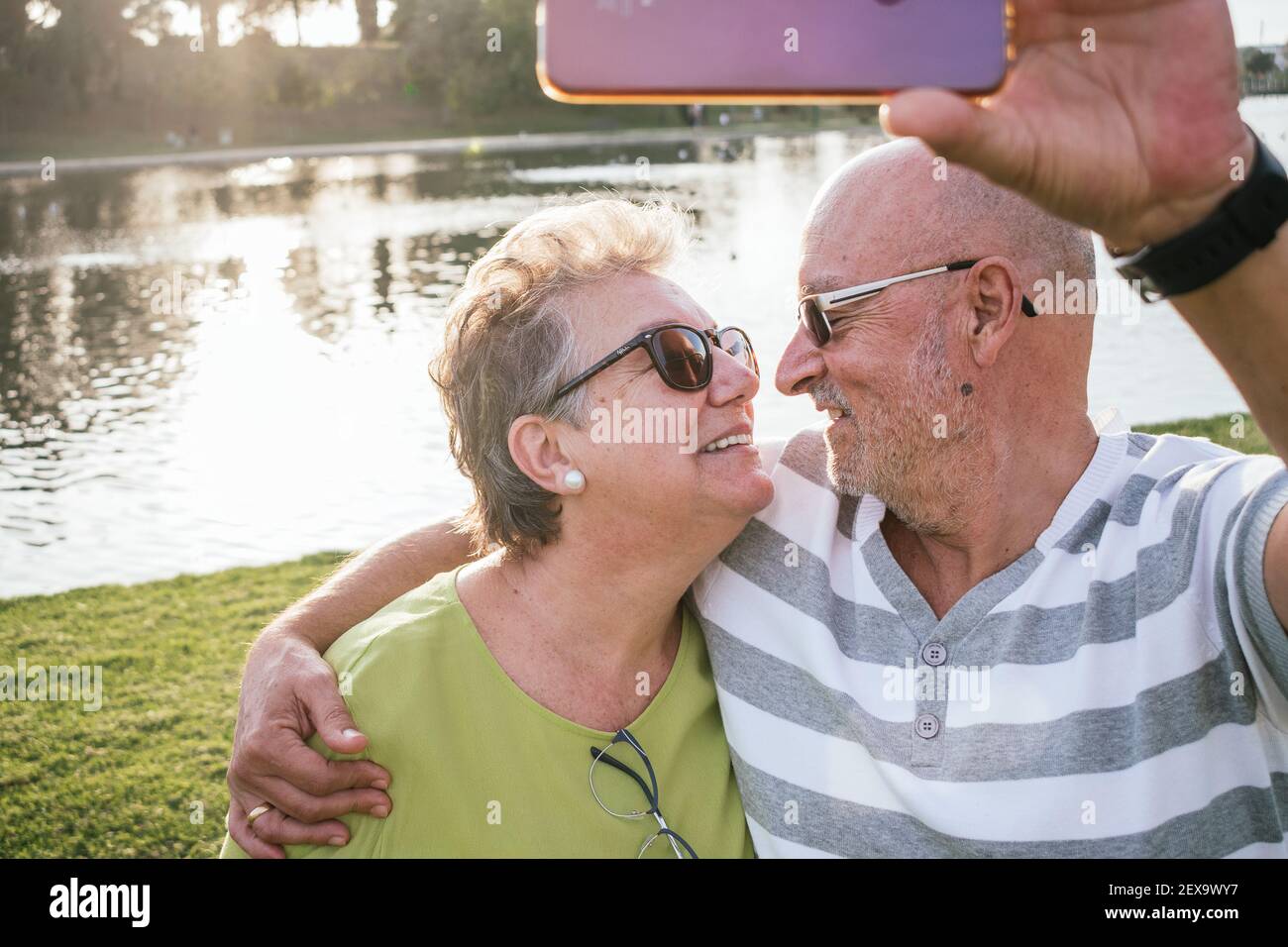 Retired couple taking a selfie in a park Stock Photo