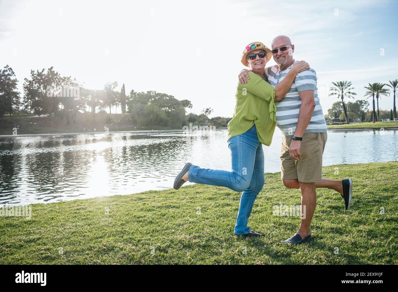 Happy retired couple in a park Stock Photo Alamy