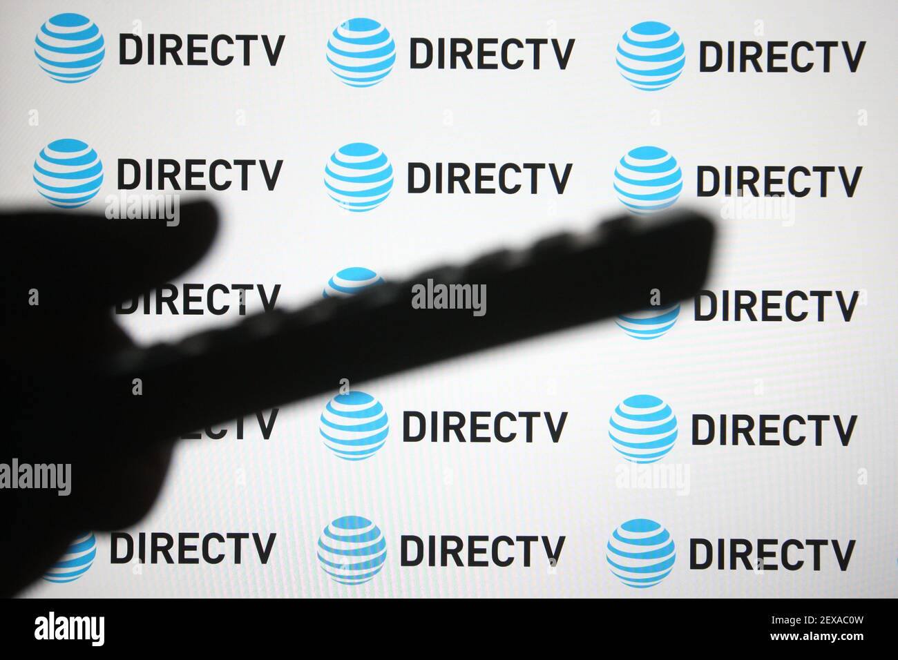 In this photo illustration a DirecTV logo of a US direct broadcast