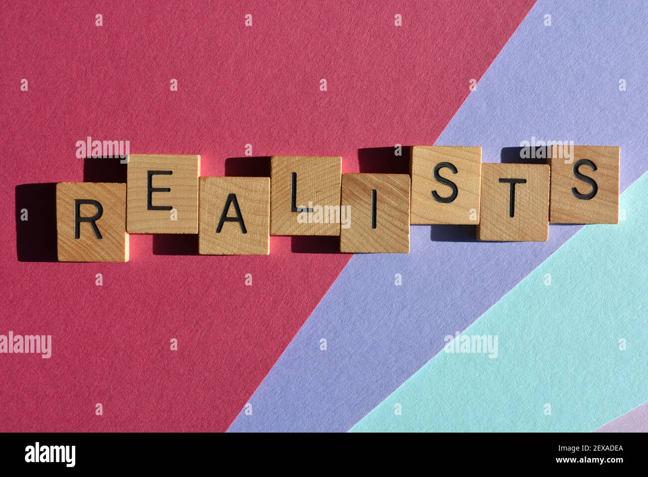 Realists, word in wooden alphabet letters isolated on colourful background Stock Photo