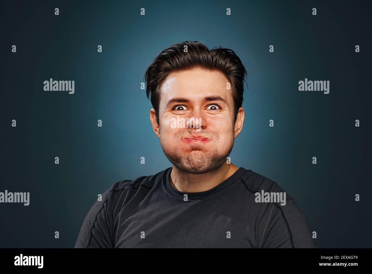 Man emotional studio portrait. Burst out laughing emotions on face. Stock Photo