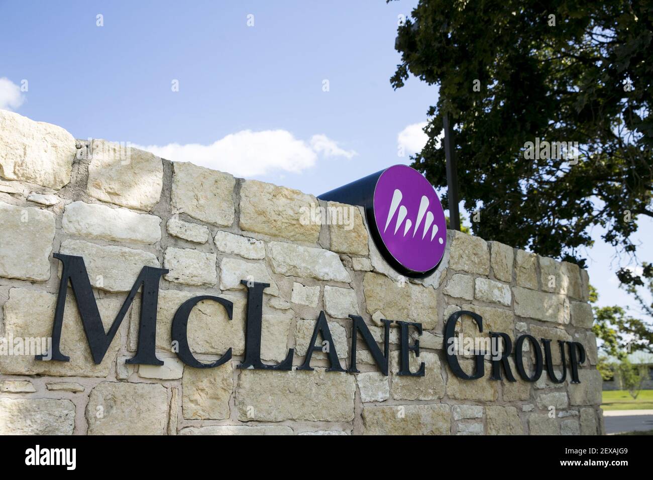 A logo sign outside of the headquarters of the McLane Group in Temple