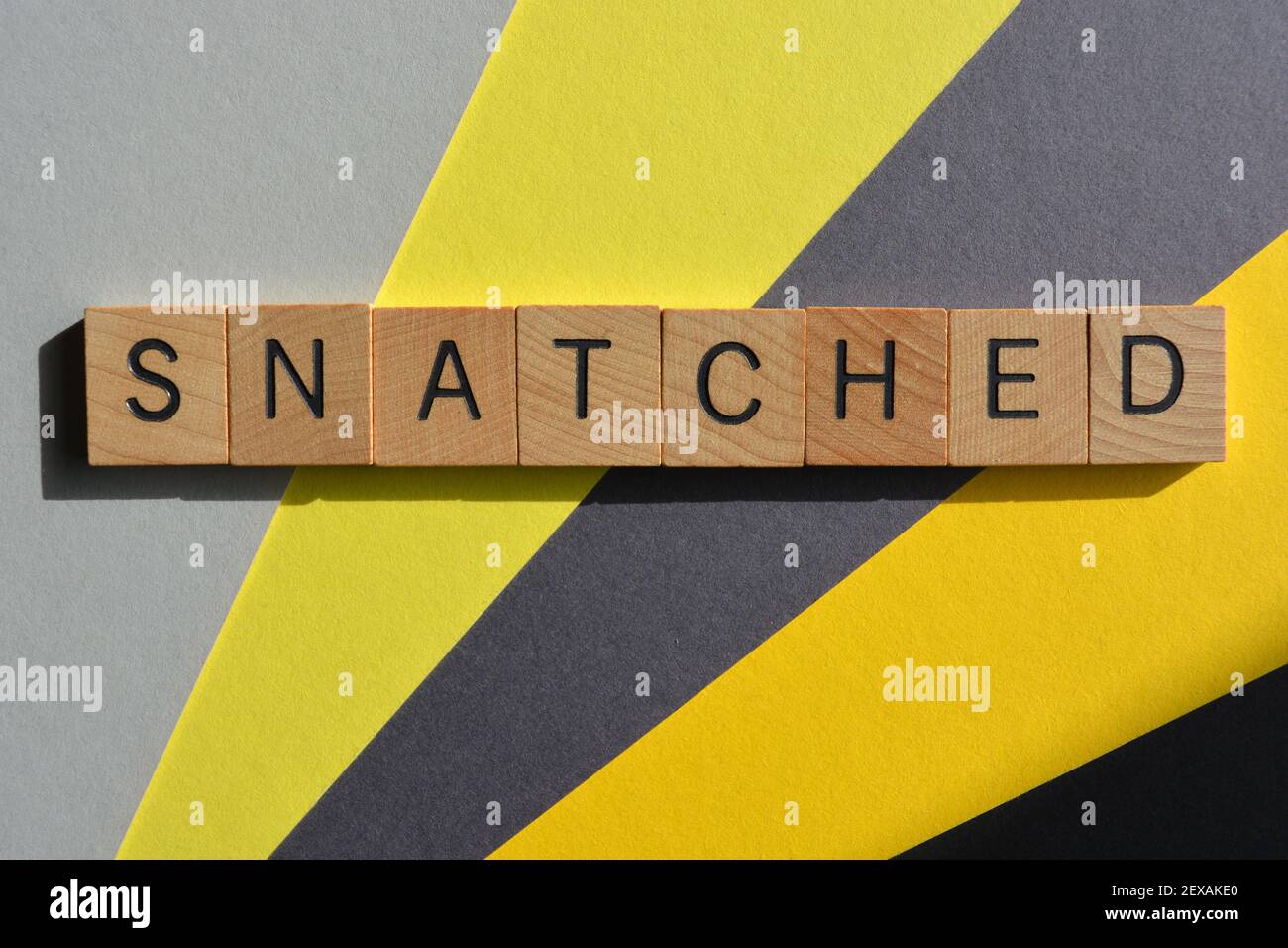 Snatched, slang word in wooden alphabet letters, used as a compliment Stock Photo