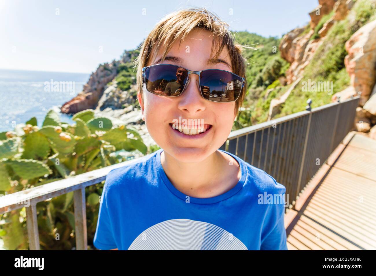 Young boy relaxed on holiday by the coast Stock Photo